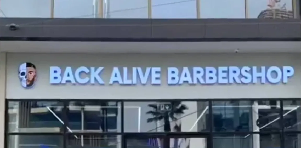 Back Alive Barbershop storefront with its illuminated sign