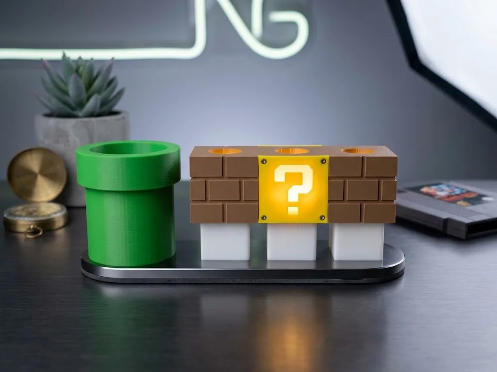 Brick block and warp pipe 3D-printed pen holders with lit question mark panel